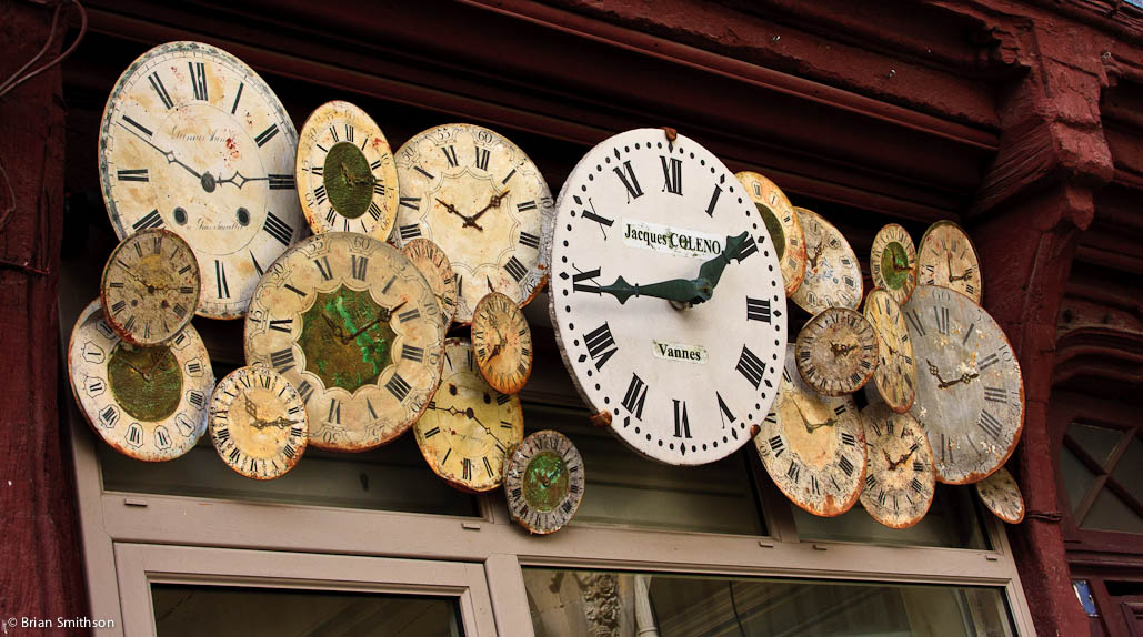 Decorative clock faces above a clock shopfront in Vannes, France